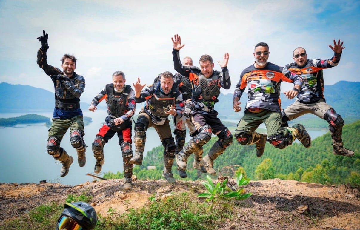 seven guys jumping in moto gear, getlostaf jersey visible